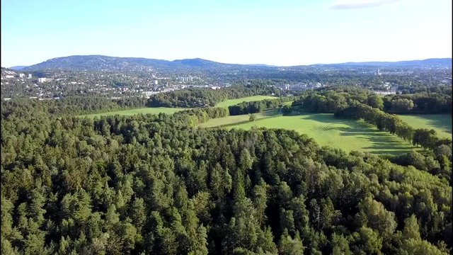 Aerial footage over trees and beach on Bygdoy, Oslo, Norway