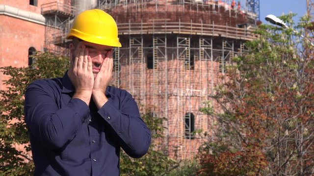 Exhausted tired stress engineer builder architect feeling headache head massage