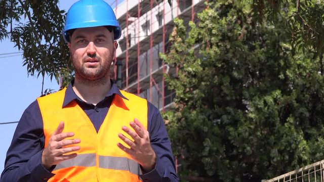 Real estate developer entrepreneur engineer with safety helmet talking explain