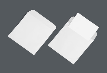 White envelope and post card on a background, top view. Blank envelope mockup and blank letterhead presentation template.