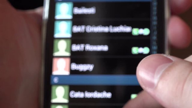 4K close up finger sliding mobile phone screen searching contact in agenda call