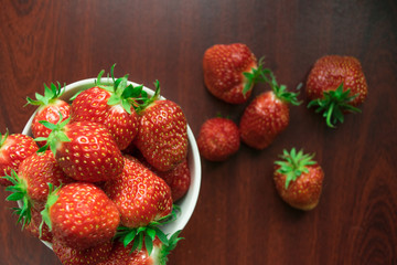 A glass of red wine and strawberries