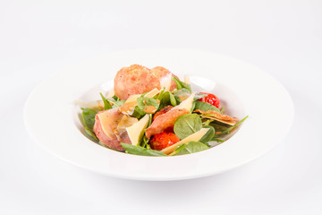 Baby spinach, dry sausage, matured cheese, roast tomatoes, thyme-balsamic vinaigrette salad on a white background