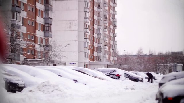 Cars covered with snow in a residential area of Moscow.