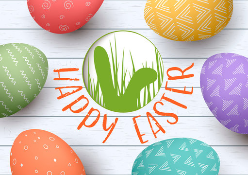 Festive ornamented easter eggs on white wooden background. Happy Easter. badge with rabbits ears silhouette.