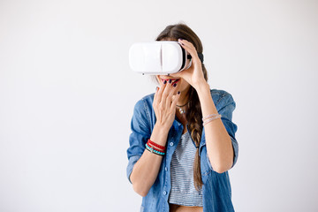 Girl portrait giggling while using VR Glasses