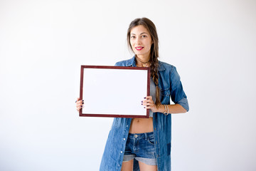 Fototapeta premium Woman holding blank white board