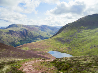 Views of Buttermere & Bleaberry Tarn on route to the summit of Red Pike with Wandope, Robinson, Dale Head and Fleetwith Pike in the distance. The English Lake District, UK.