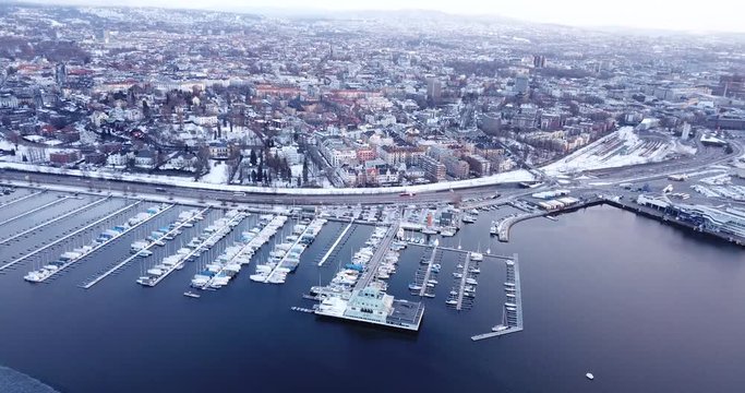Aerial footage of frozen Frognerkilen Marina in Oslo, Norway in winter 2018