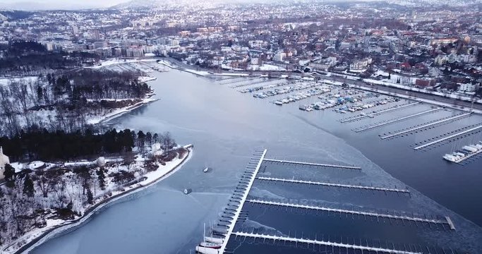 Aerial footage of frozen Frognerkilen Marina in Oslo, Norway in winter 2018