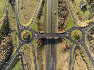 Aerial birds eye view of the M7 motorway in Ireland. Motorway with bridge, roundabouts, and movement.