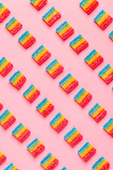 Colorful candies pattern on a pink background.