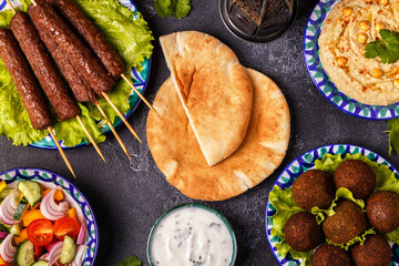 Classic kebabs, falafel and hummus on the plates.