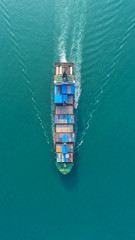 Container ship in export and import business and logistics. Shipping cargo to harbor by crane. Water transport International. Aerial view - obrazy, fototapety, plakaty