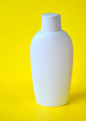 empty white packaging shampoo / shower gel / body lotion / lotion / medicine remover isolated on a yellow background