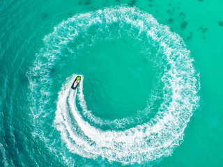 People are playing a jet ski in the sea.Aerial view. Top view.amazing nature background.The color...