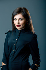 Portrait of an attractive young woman in black shirt in studio
