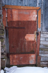 A locked door of an old wooden house