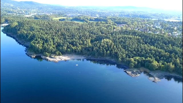 Aerial footage from drone over trees on Bygdoy, Oslo, Norway