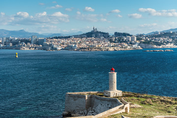 View on the Chateau d'If Lighthouse on Castle IF fortress-island with Marseille in the background, Provence, France. The chateau was made famous by the Alexandre Dumas novel The Count of Monte Cristo.