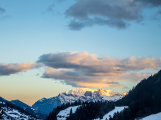 An early sunrise on the snowcapped mountains in Switzerland