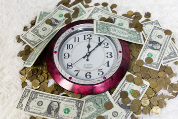 Time is money law of business. Mechanical aces lie on a pile of coins and money.
