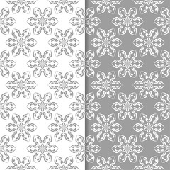 White and gray floral backgrounds. Set of seamless patterns
