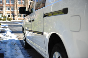 White delivery mini truck stands near building