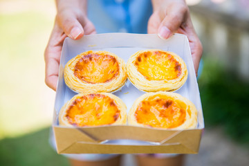 Freshly baked delicious egg tart on paper box