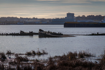 Fototapeta premium a view of river Thames during the sunset on a sunny day in industrial part of Thames estuary near Rainham naturre reserve