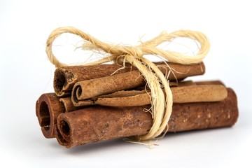 Cinnamon pieces on a white background. Sales of aromatic spices.