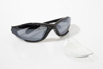 Sun glasses and lens in a white background composition