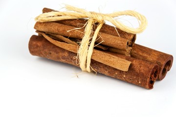 Cinnamon pieces on a white background. Sales of aromatic spices.