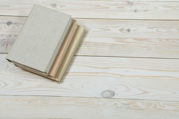 Pile of old pastel colors books stacked.