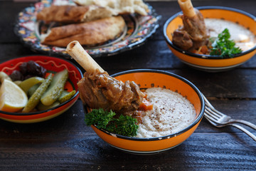 Lamb shank with puree and parsley in bowl