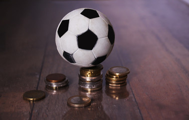 A Football or soccer ball and a pile of money