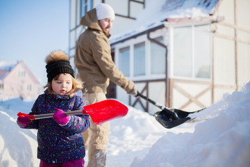 Little girl with a snow shovel.
