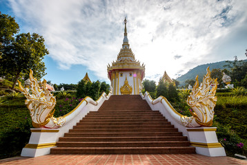 Fototapeta premium buddhist monastery , naga statue on stair at temple . cloudy and blue sky background . beautiful architecture and ancient landmark of thailand .