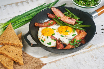Traditional Breakfast, eggs with bacon and herbs