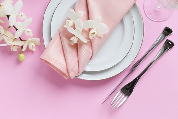 Festive table setting for Valentines Day, Easter, Mother's Day ore wedding. Elegant table decoration with fresh orchid. Overhead view with copy spase