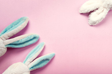 Toy rabbits ears, flatlay on pink background with copy space for text.