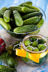 Raw cucumbers, horseradish on wooden background