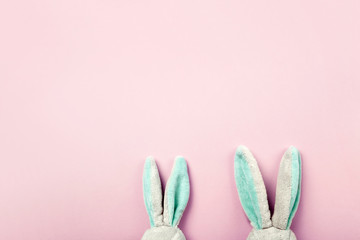 Toy rabbits ears, flatlay on pink background with copy space for text.