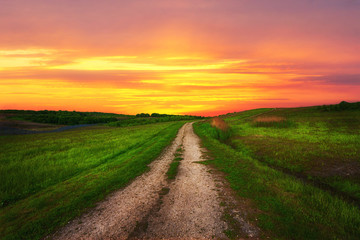 Countryside path on the background of a beautiful sunset