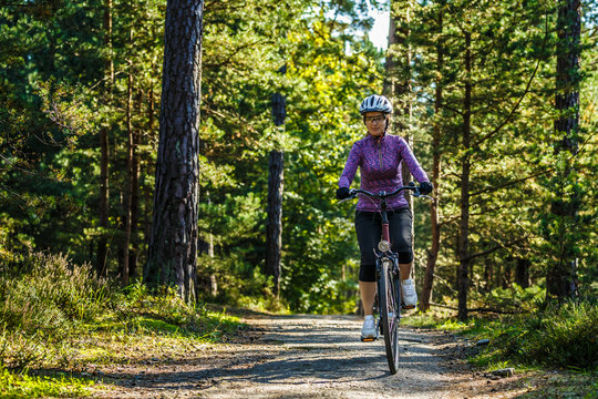 Woman riding bike in forest