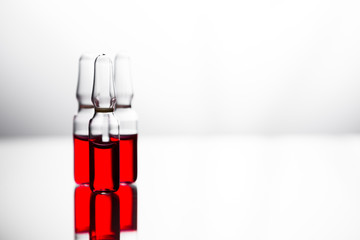 Group of ampoules with a transparent medicine in medical laboratory