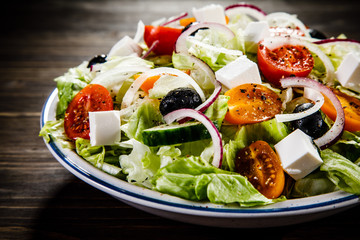 Greek salad on wooden background