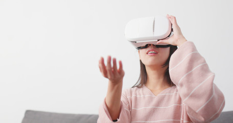 Woman play with VR device at home