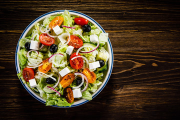 Greek salad on wooden background