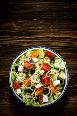 Greek salad on wooden background